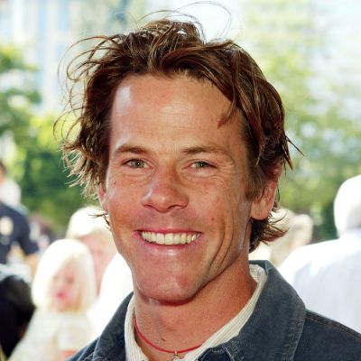 He is at an event smiling for the camera.